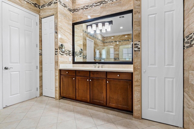 bathroom featuring tile patterned flooring, vanity, and tile walls