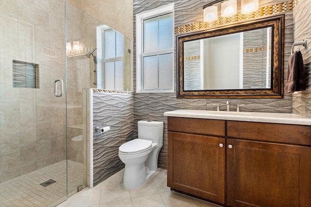 bathroom with vanity, a shower with door, tile patterned floors, and toilet