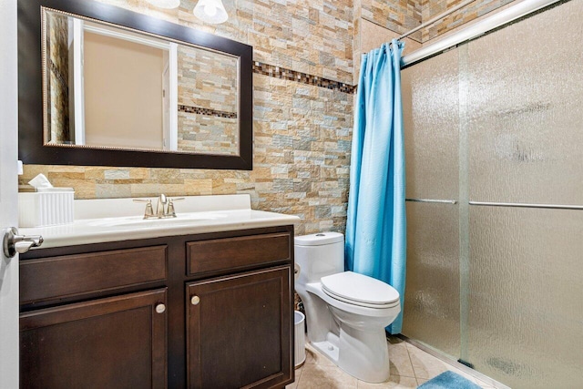 bathroom with vanity, curtained shower, tile patterned floors, and toilet