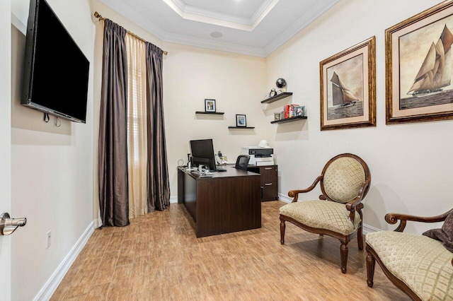 office area featuring a raised ceiling, crown molding, and light hardwood / wood-style floors