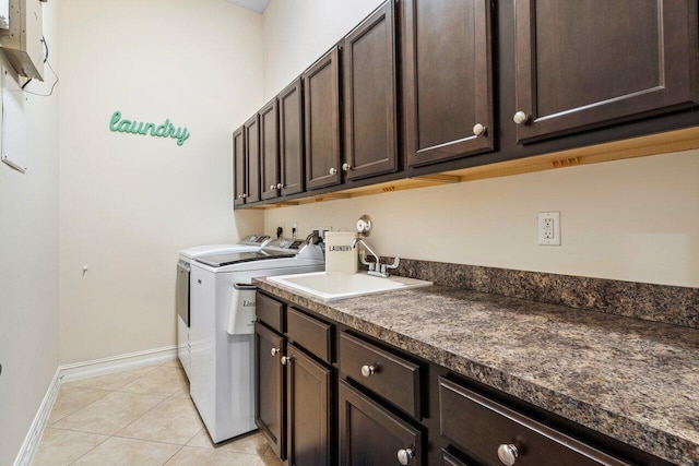 laundry area with sink, cabinets, light tile patterned floors, and washer and dryer