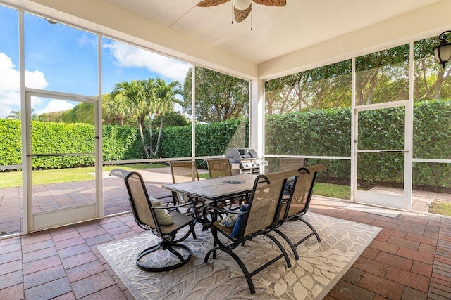 sunroom / solarium featuring ceiling fan