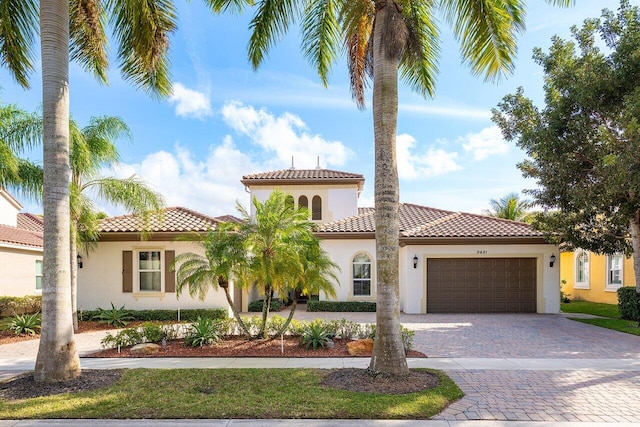 mediterranean / spanish-style home featuring a garage