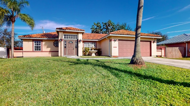 mediterranean / spanish house with a garage and a front lawn