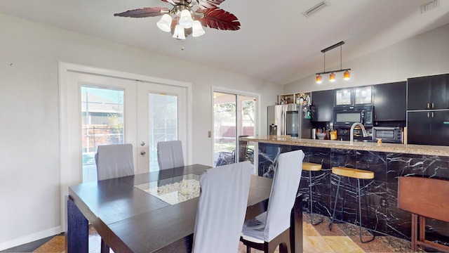 dining room with french doors, ceiling fan, and vaulted ceiling