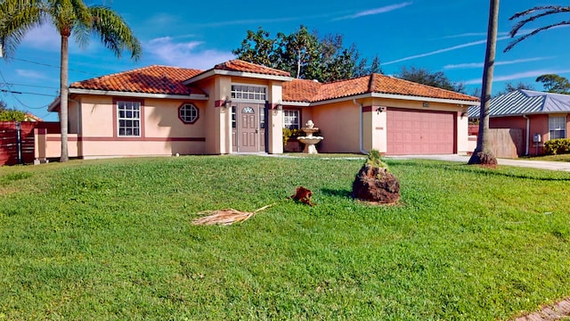 mediterranean / spanish-style home featuring a garage and a front lawn