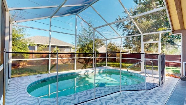 view of pool featuring glass enclosure