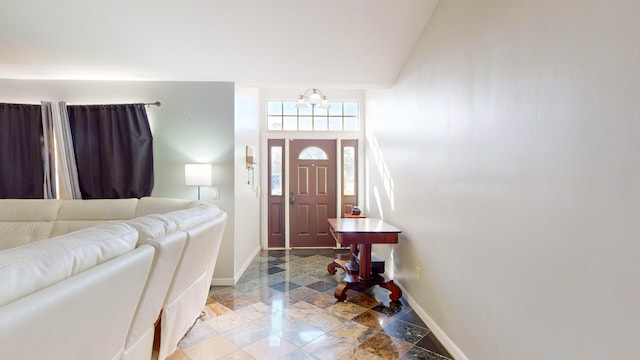 entrance foyer featuring vaulted ceiling and a notable chandelier