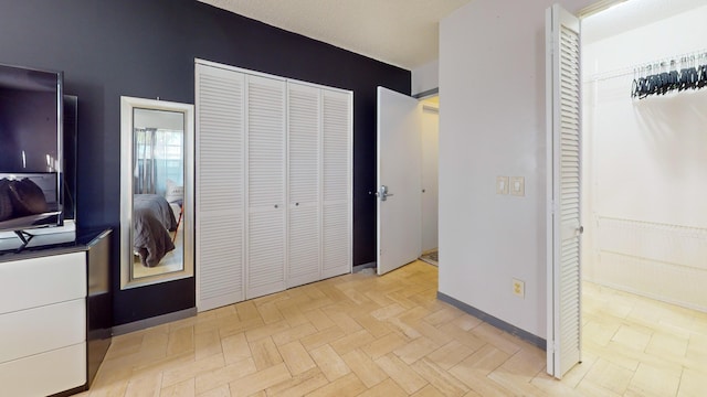 unfurnished bedroom featuring a textured ceiling and light parquet floors