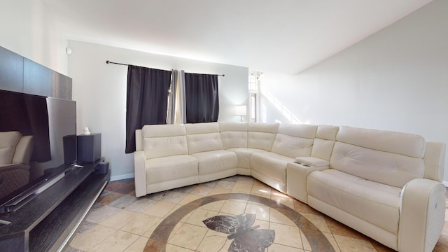 tiled living room featuring vaulted ceiling