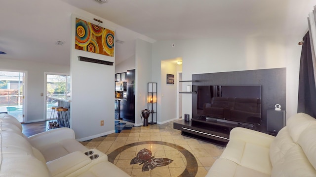 tiled living room with lofted ceiling