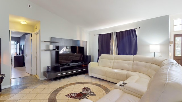 living room featuring lofted ceiling and plenty of natural light