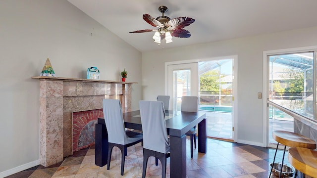 dining area featuring ceiling fan, vaulted ceiling, and a wealth of natural light