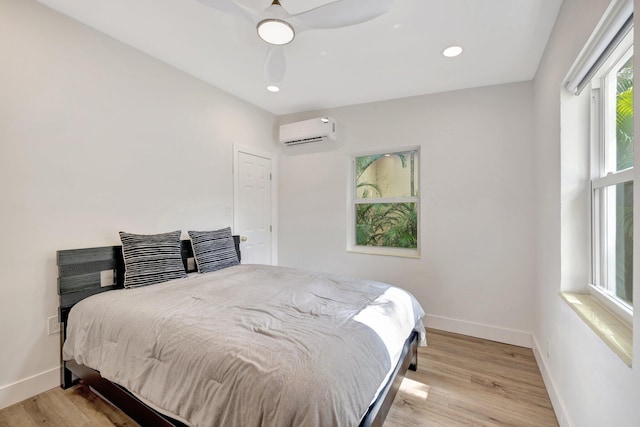 bedroom featuring baseboards, a wall mounted air conditioner, light wood-type flooring, recessed lighting, and a ceiling fan