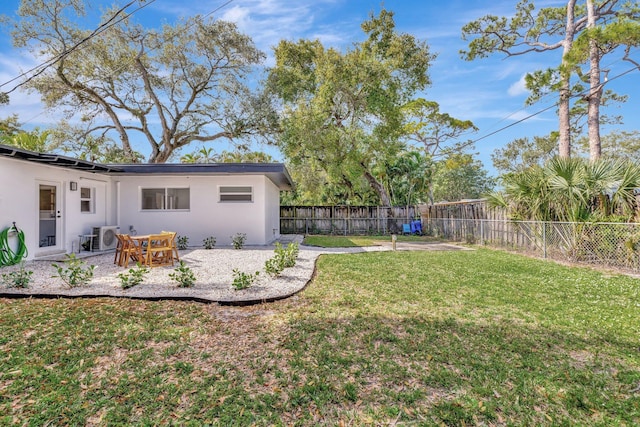 view of yard with a patio, ac unit, and a fenced backyard