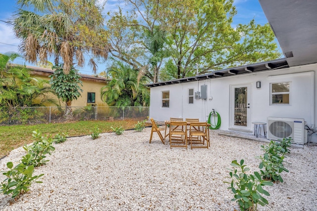 exterior space with a patio, ac unit, outdoor dining area, and fence