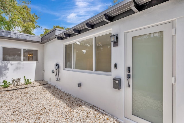 entrance to property featuring stucco siding