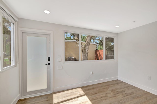 interior space with recessed lighting, baseboards, and wood finished floors