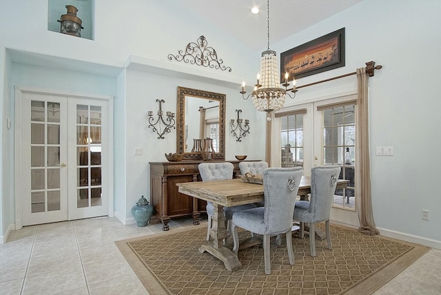 dining room featuring light tile patterned flooring, a chandelier, high vaulted ceiling, and french doors