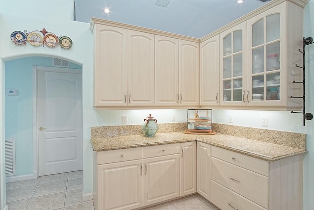 kitchen with light stone countertops and light tile patterned flooring