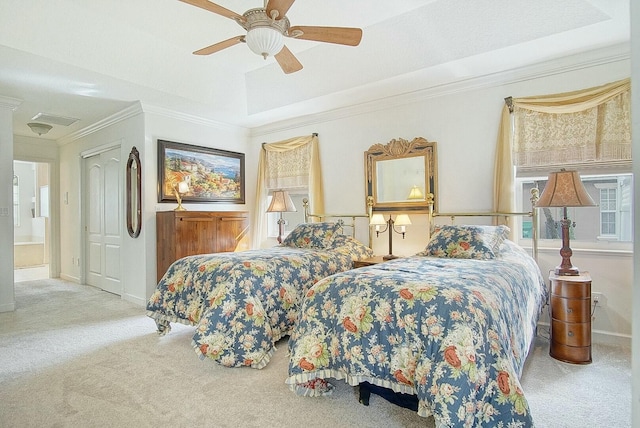 bedroom with ornamental molding, light colored carpet, a raised ceiling, and ceiling fan