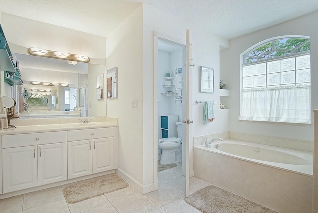 bathroom featuring a healthy amount of sunlight, a bath, a textured ceiling, and toilet