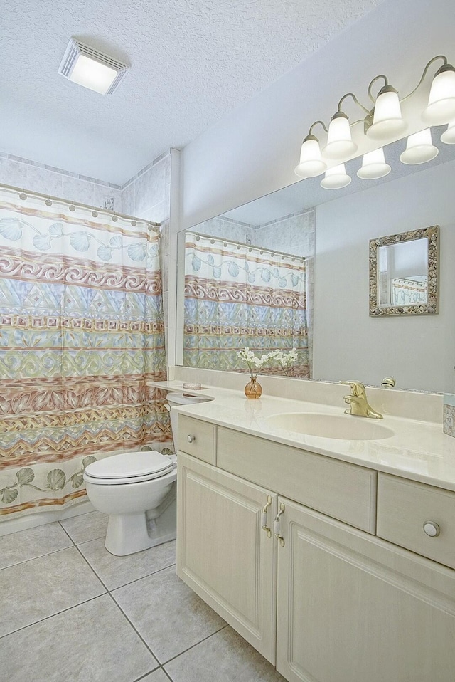 bathroom with curtained shower, tile patterned flooring, vanity, toilet, and a textured ceiling