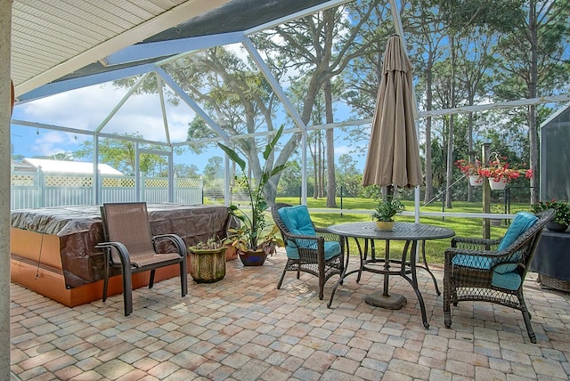 view of patio featuring a hot tub and a lanai