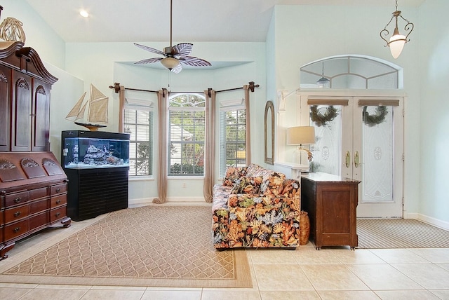 sitting room with light tile patterned flooring, ceiling fan, and french doors