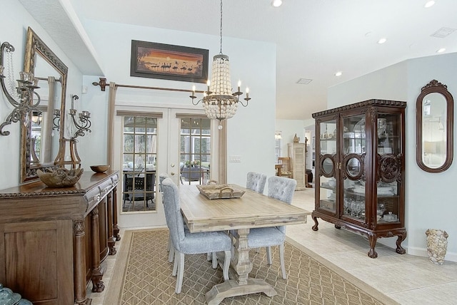 dining room with light tile patterned flooring, a notable chandelier, and french doors