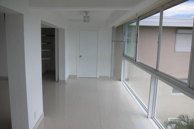 hall with light tile patterned floors