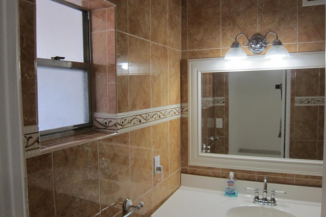 bathroom featuring tile walls and vanity