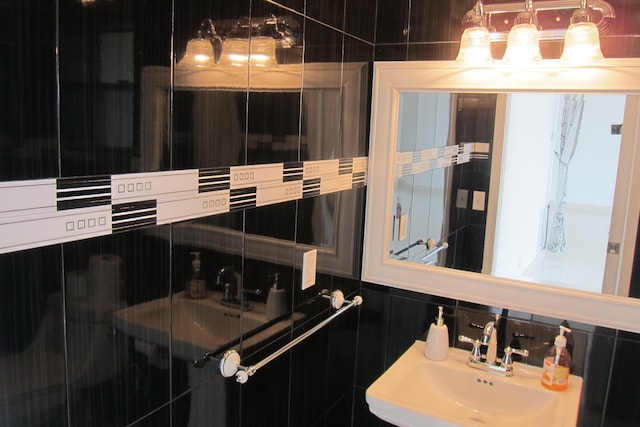 bathroom with sink and tile walls