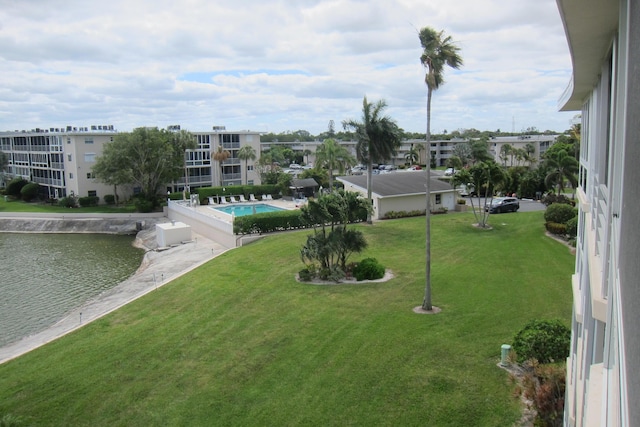 exterior space with a water view and a lawn