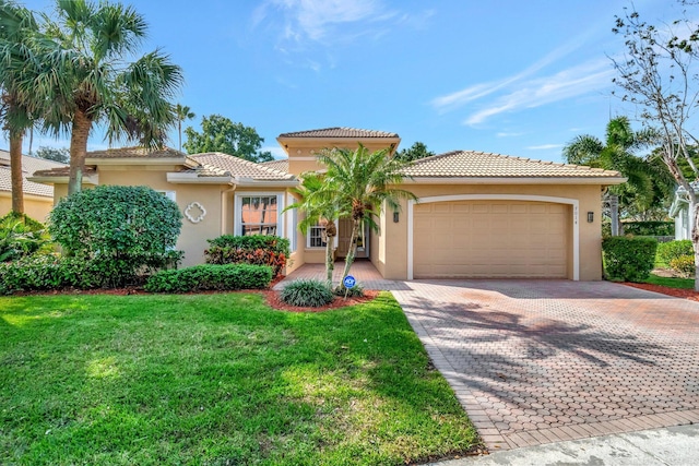 mediterranean / spanish home featuring a garage and a front yard