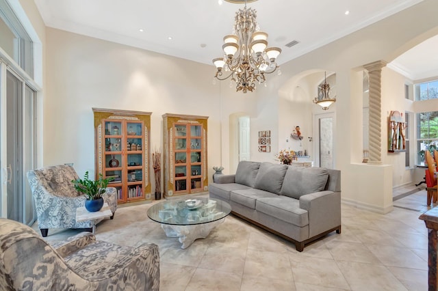 living room featuring crown molding, a towering ceiling, decorative columns, and light tile patterned floors