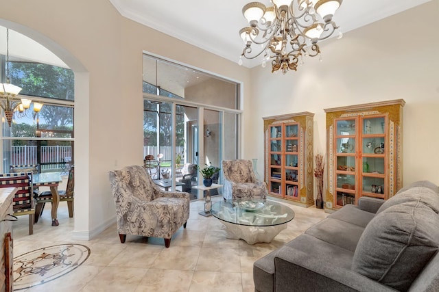 tiled living room with an inviting chandelier, a towering ceiling, ornamental molding, and a healthy amount of sunlight