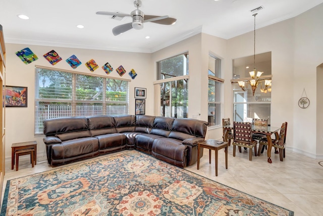 living room with ornamental molding, ceiling fan with notable chandelier, and light tile patterned floors