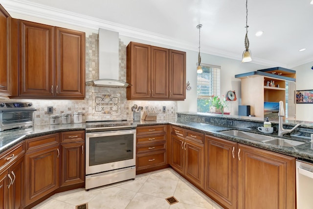 kitchen featuring pendant lighting, sink, stainless steel appliances, dark stone counters, and wall chimney exhaust hood