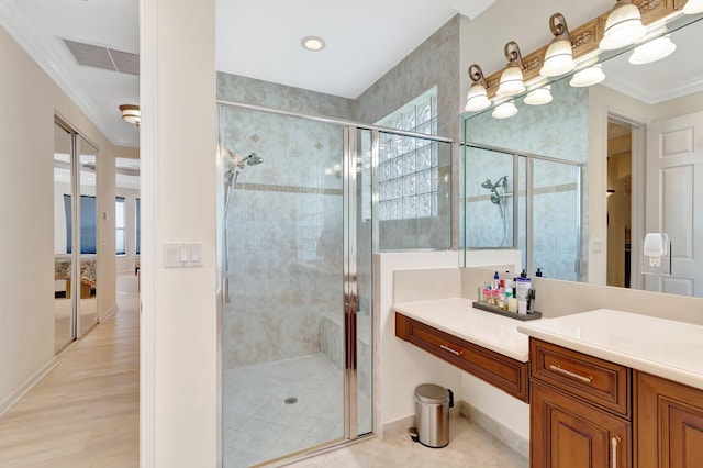 bathroom with vanity, ornamental molding, and a shower with shower door