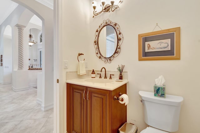 bathroom with ornate columns, vanity, tile patterned flooring, and toilet