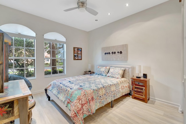 bedroom with ceiling fan and light wood-type flooring