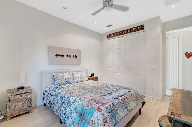 bedroom featuring a closet, ceiling fan, and light wood-type flooring