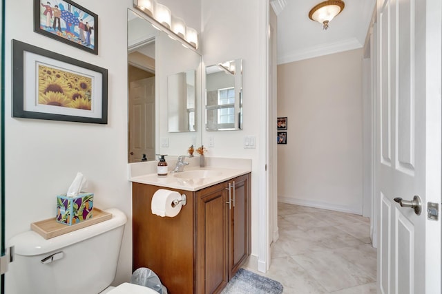 bathroom with vanity, ornamental molding, and toilet