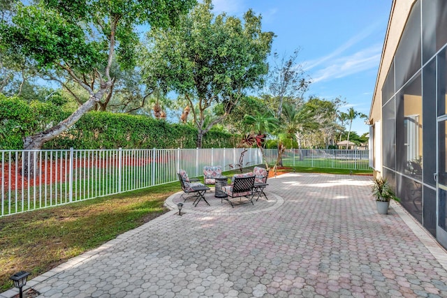 view of patio featuring a lanai