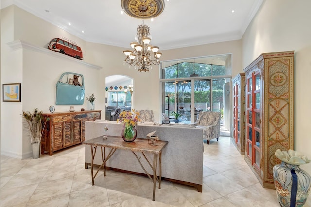 living room featuring a towering ceiling, ornamental molding, light tile patterned floors, and a notable chandelier