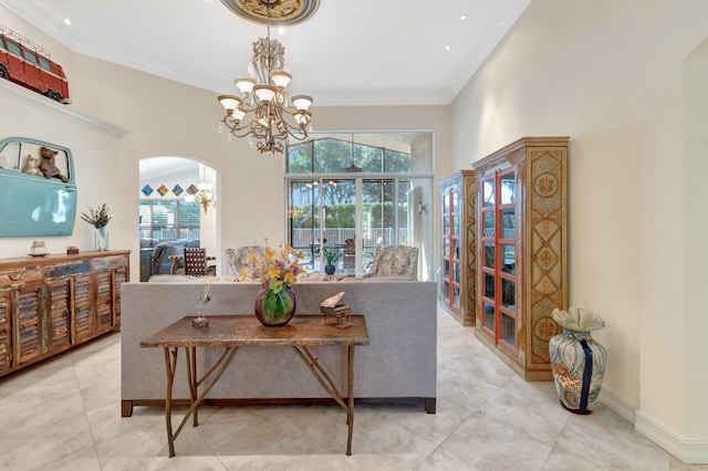 dining room with an inviting chandelier, a towering ceiling, and ornamental molding