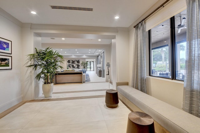 hall with tile patterned floors