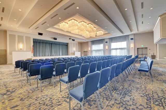 home theater room featuring a tray ceiling and carpet