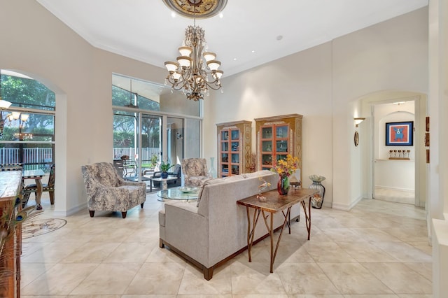 living room featuring light tile patterned flooring, plenty of natural light, a towering ceiling, and an inviting chandelier